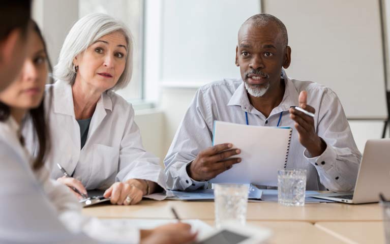 hospital administrator talks with medical staff