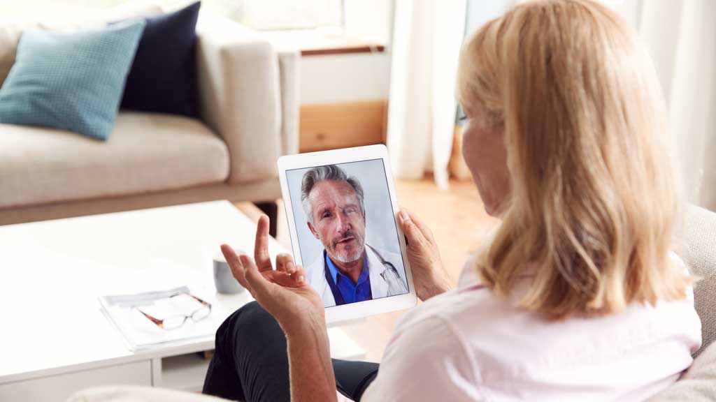 patient using tablet talking to doctor