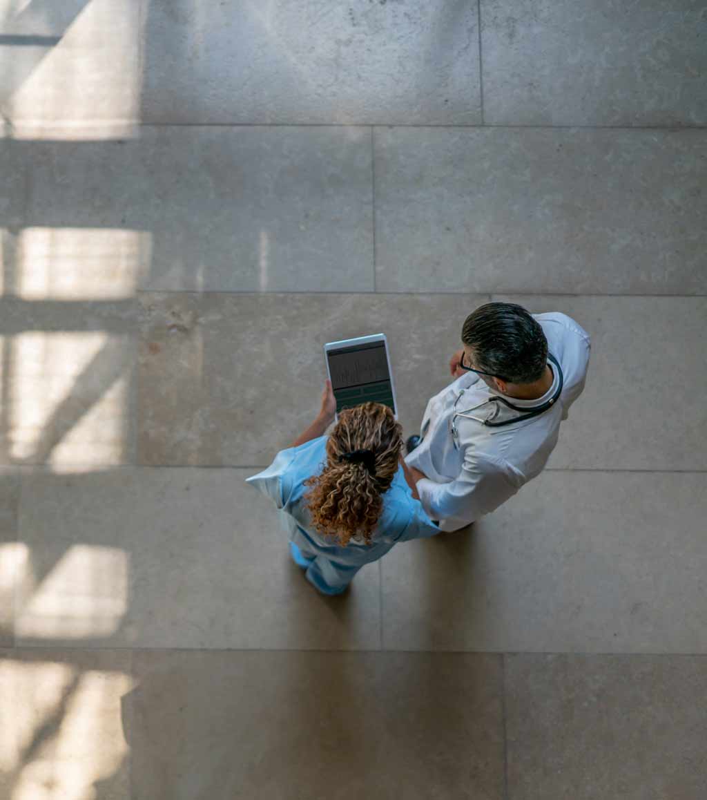 Female-nurse-showing-something-to-doctor-on-tablet