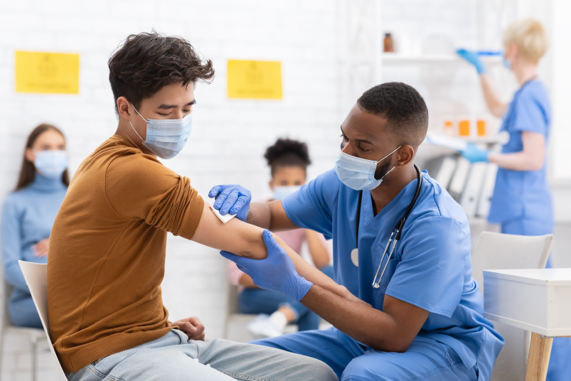 Man preparing to get vaccine in arm