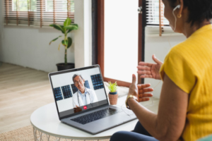 Doctor and patient talking virtually using computer