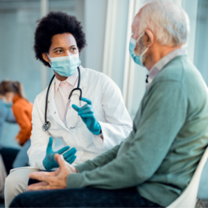 Doctor and patient wearing masks having a conversation