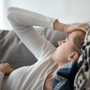 Sick woman laying on couch